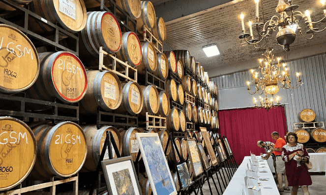 Stacked wine barrels with a large table and chandeliers at the Messina Hof Winery in Bryan, an example of what you can do during a romantic Texas getaway