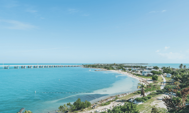 An aerial Bahia Honda State Park with light blue skies a bridge a great place for snorkeling in the florida keys