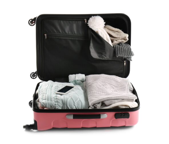 a pink suitcase with clothes in it