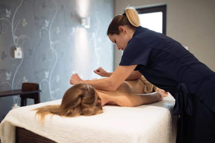 a woman massaging a woman's back