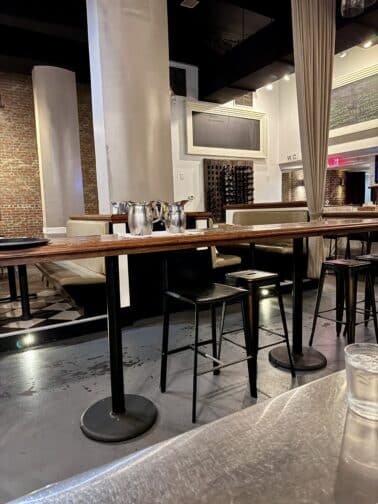 a table with chairs and glasses in a room