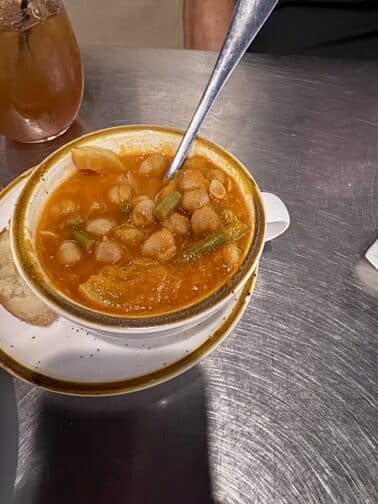 a bowl of soup with a spoon on a plate