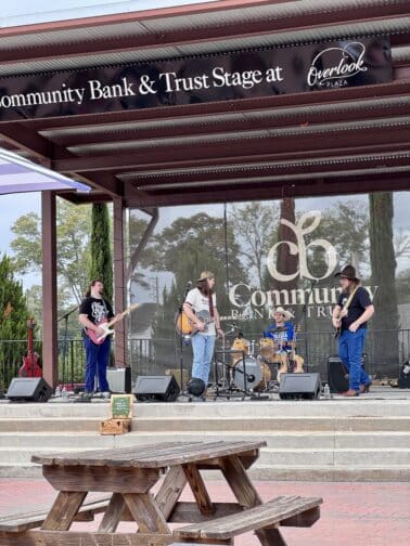 a group of people playing instruments on stage