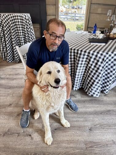 a man sitting on a chair with a dog