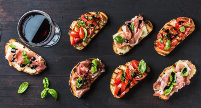 a group of toasted bread with different toppings