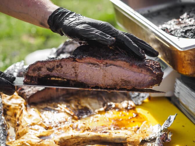 a person holding a piece of meat