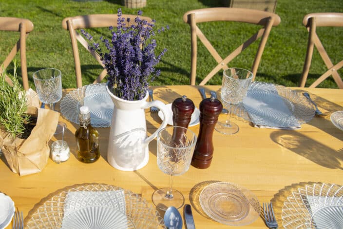 a table with a vase of lavender and salt and pepper shakers