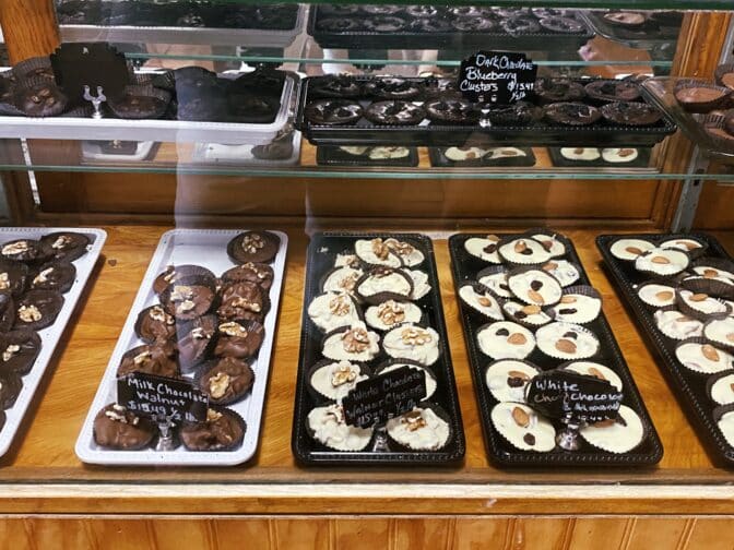 a display case with trays of cookies