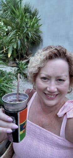 a woman holding a cup with straw